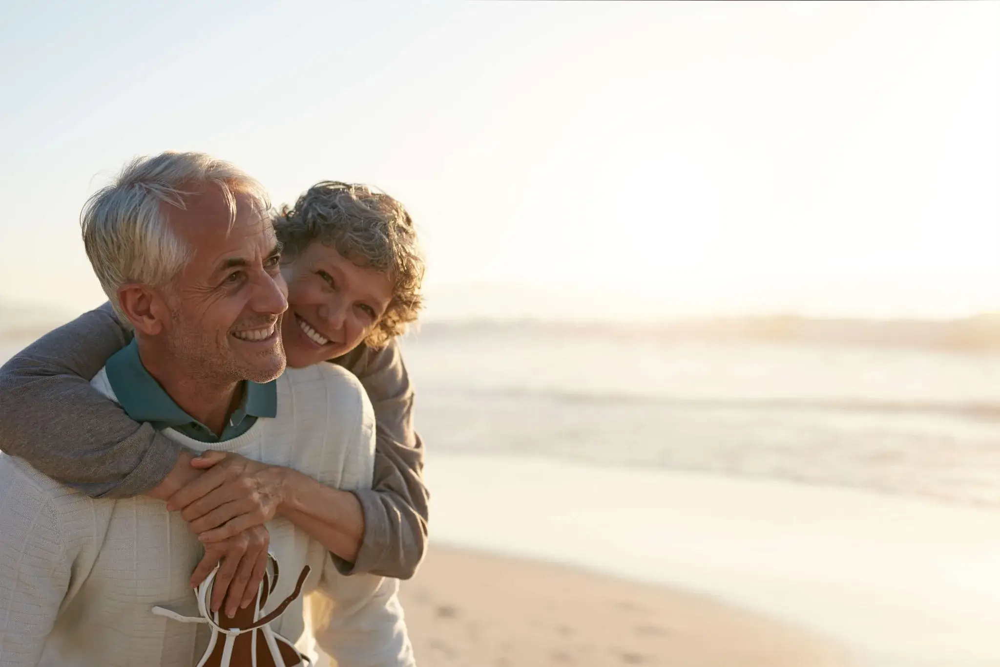 Elderly couple embracing on the beach - Sonoma County and Petaluma Estate Planning Attorneys