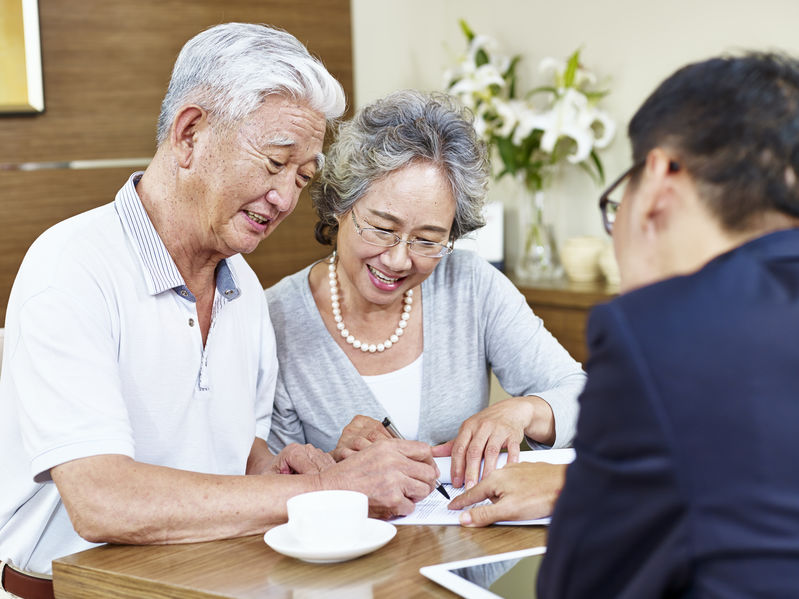 elderly Asian couple sitting on a couch – Petaluma elder law attorneys