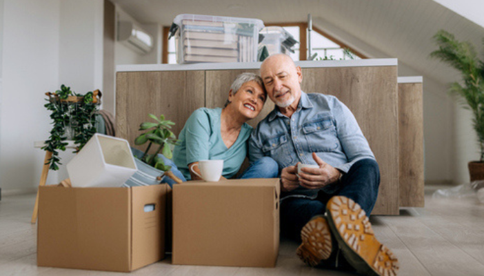 How To Downsize in Retirement older couple with moving boxes