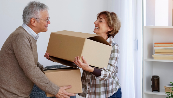 How to Know When It's Time to Downsize. Older adults packing boxes.