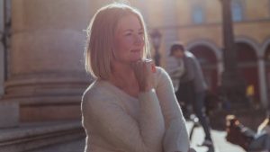 Can You Disinherit a Spouse in California, image of pensive middle-aged woman outside