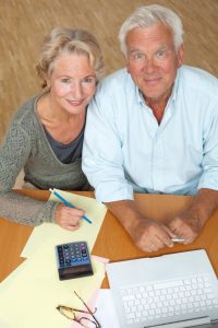 how often should I update my estate plan, image of senior couple crunching numbers
